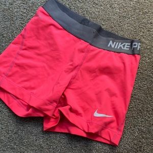 Size small neon pink Nike pros